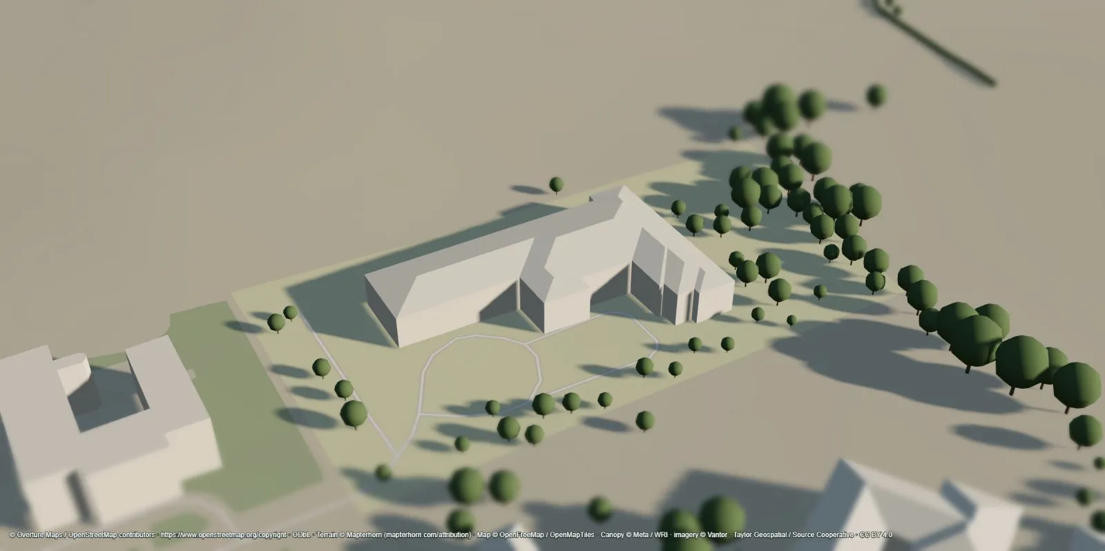 Building with a reconstructed hip roof following its L-shaped footprint